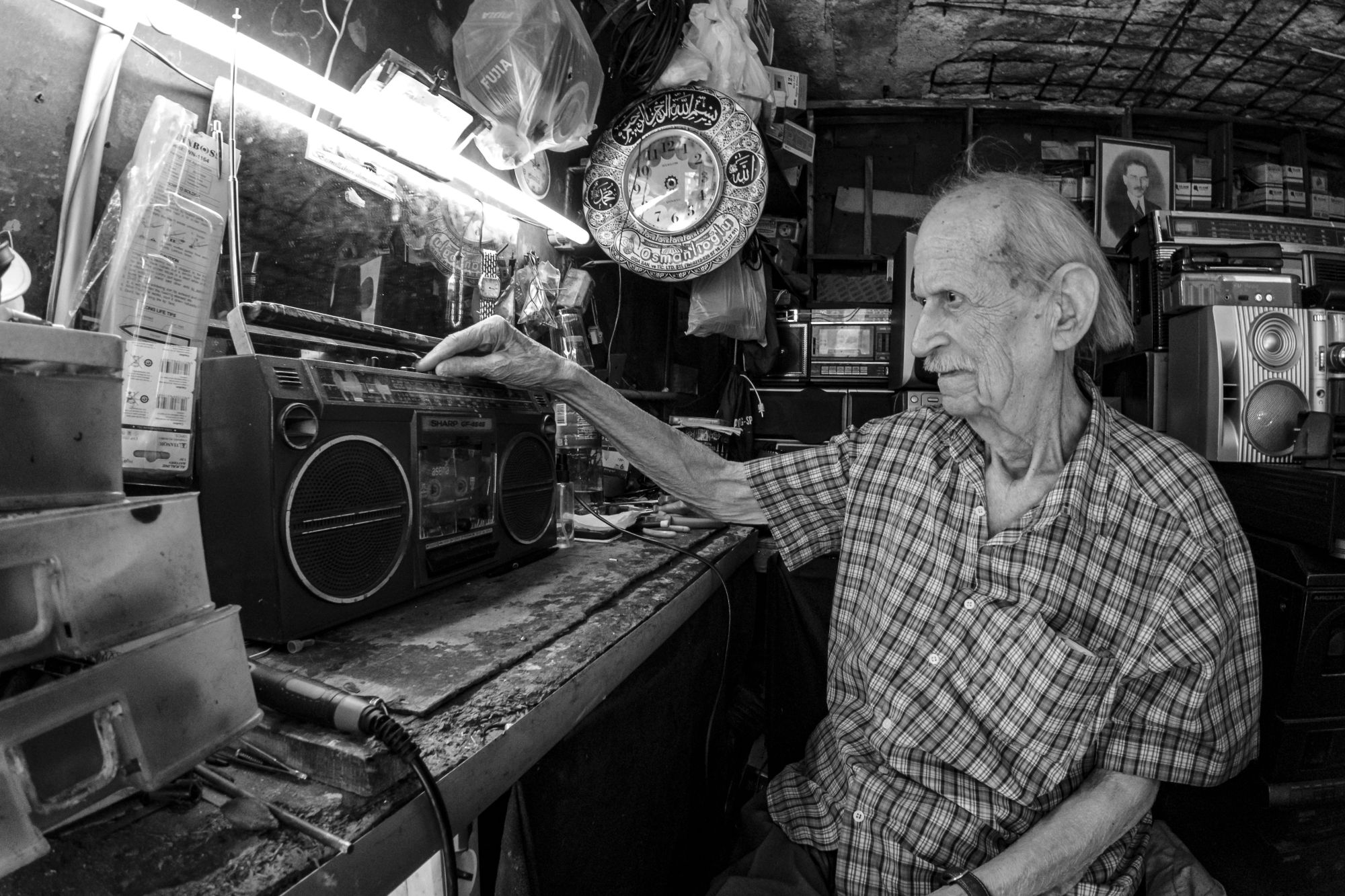 Craftsman repairing a vintage radio at his workbench