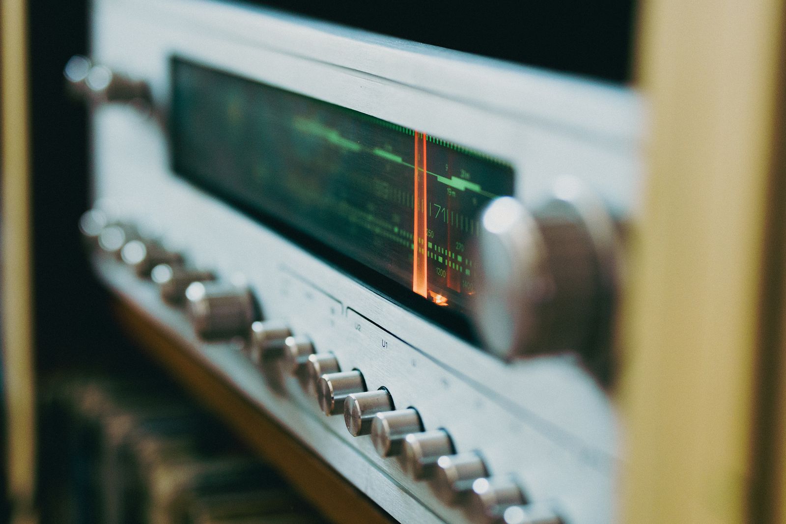 Close-up of a vintage radio tuning dial lit from within